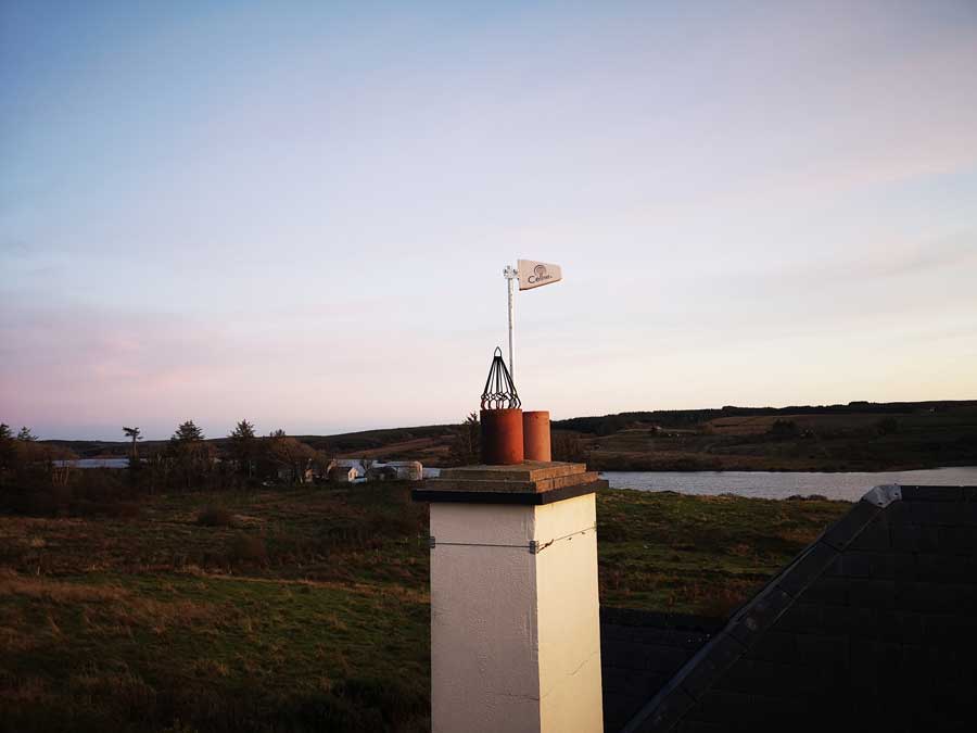 Rooftop antenna in a customer's house in Kilfenora under a bluish sunset sky.